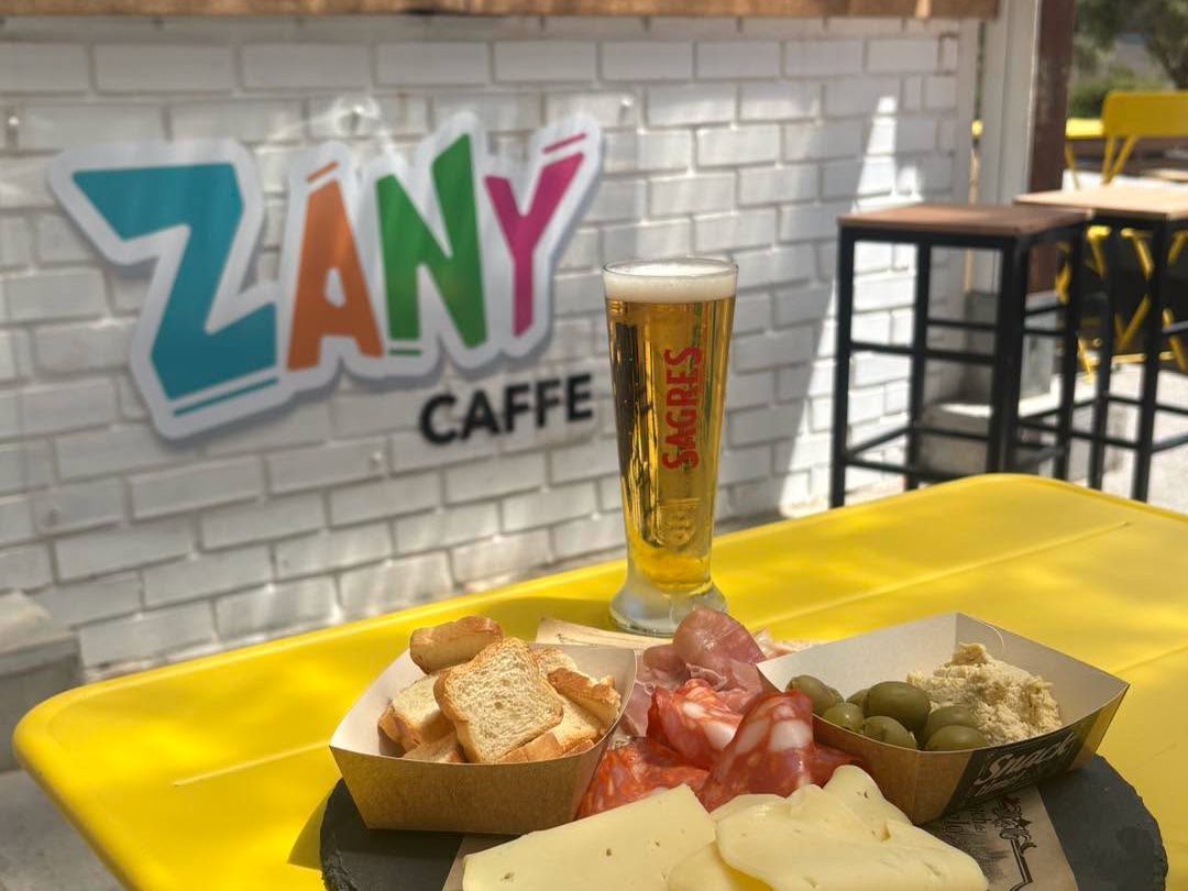 Cheese and charcuterie board with a beer