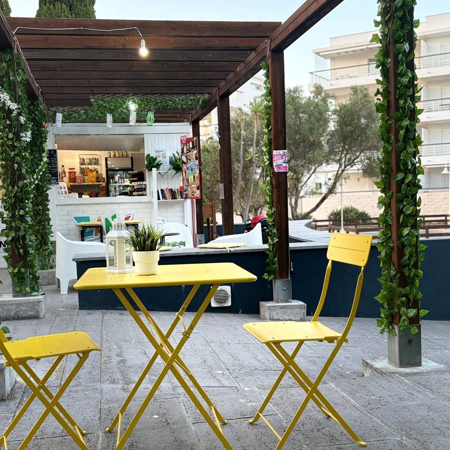 Bistro tables under the pergola at dusk