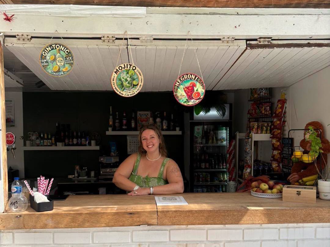 The bar counter with cocktail signs hanging above it