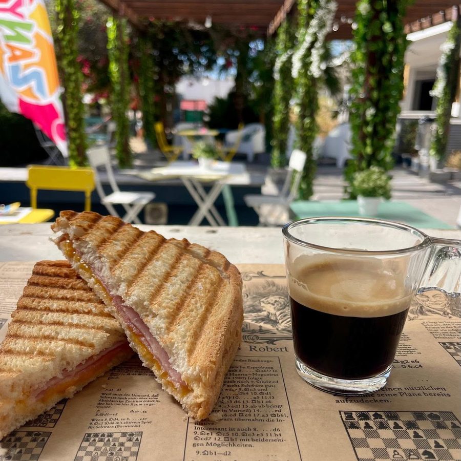Toasted ham and cheese sandwich with an espresso